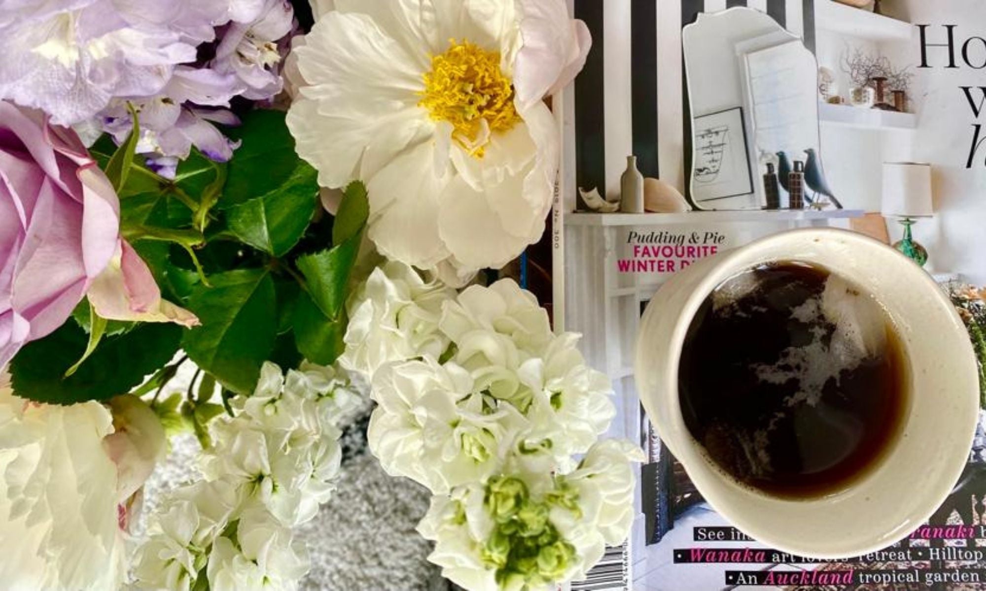 A cup of coffee among flowers