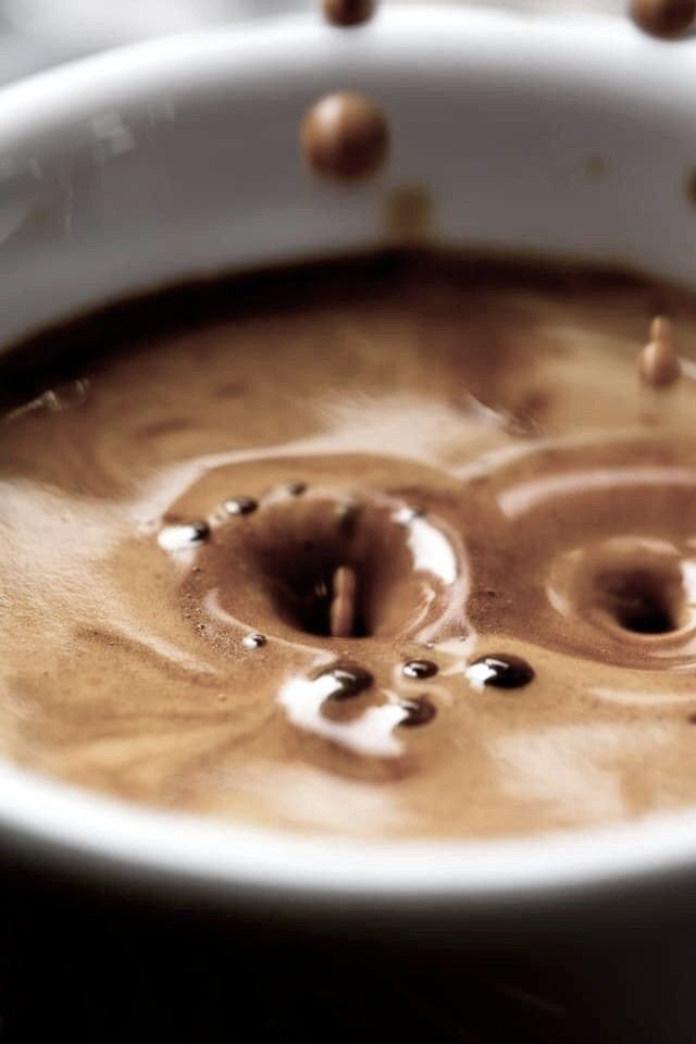 Coffee splashing into a cup