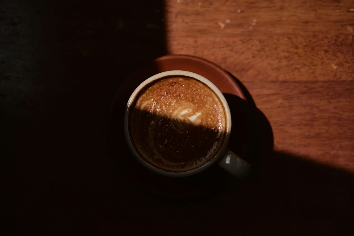 A cup of black coffee in low light