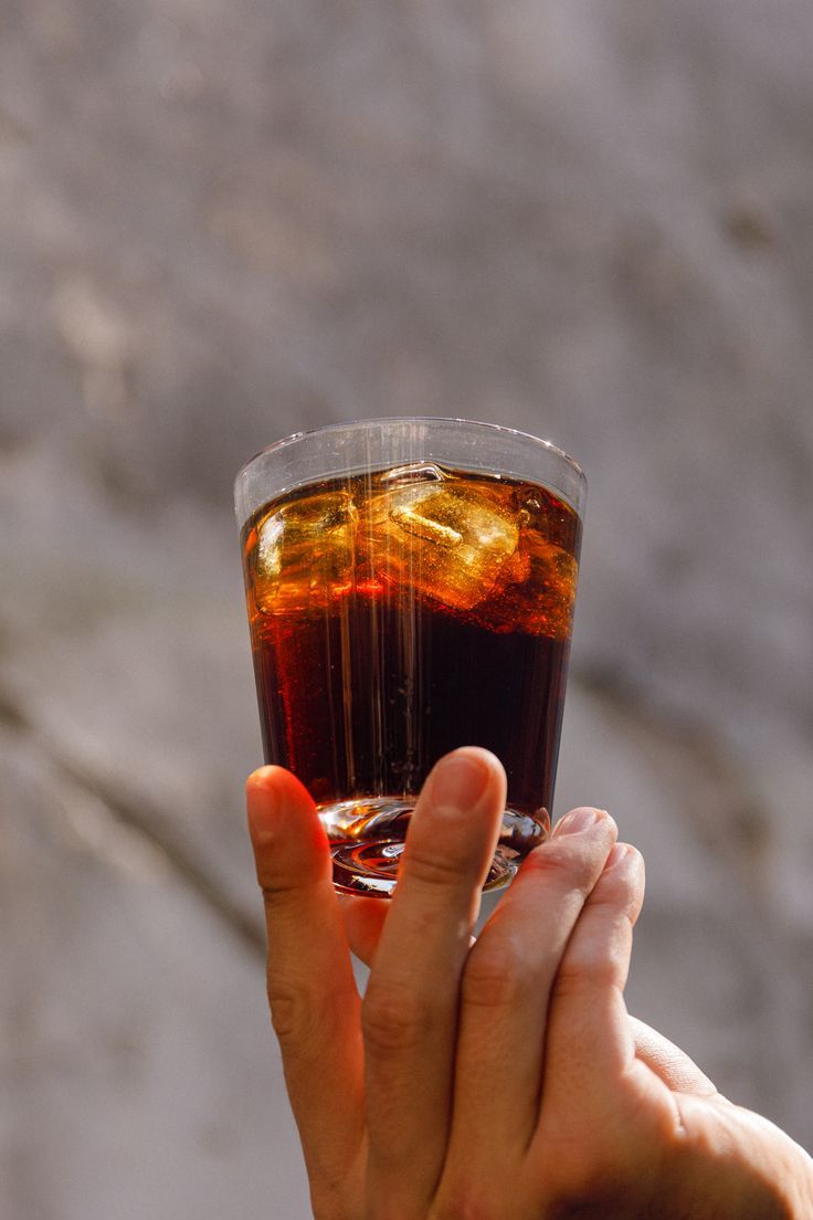 An iced coffee held up to the light